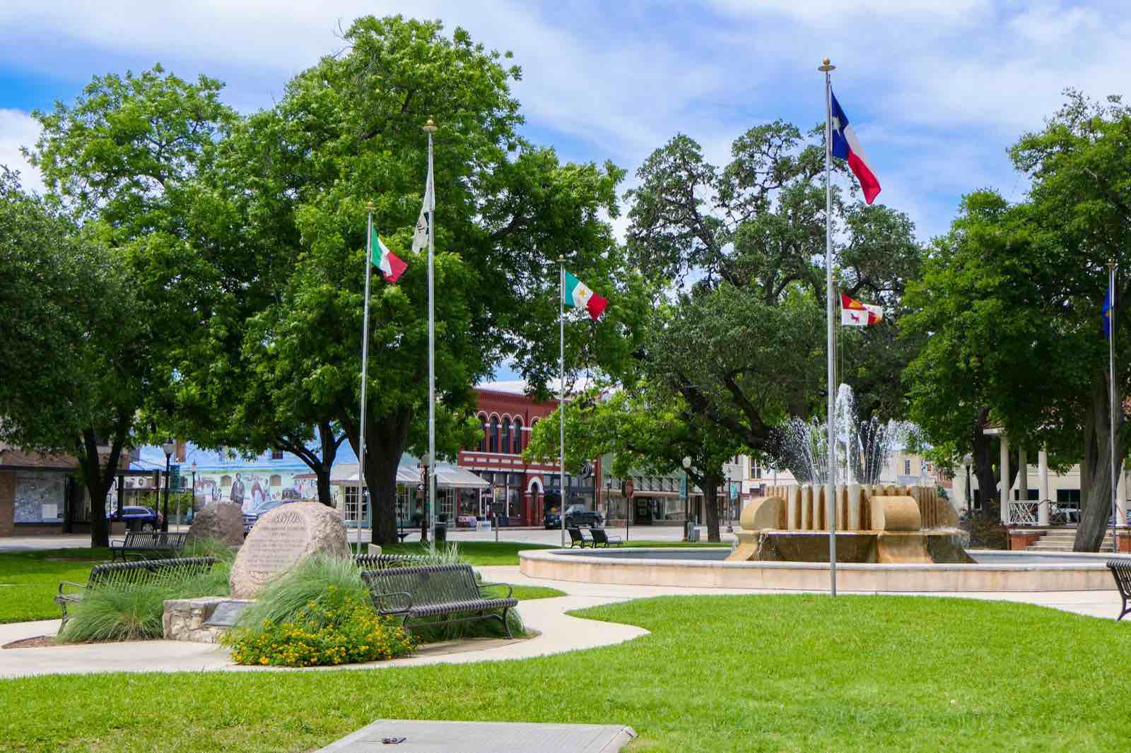 Downtown Seguin: the fountain, flags, and live oaks on the square
