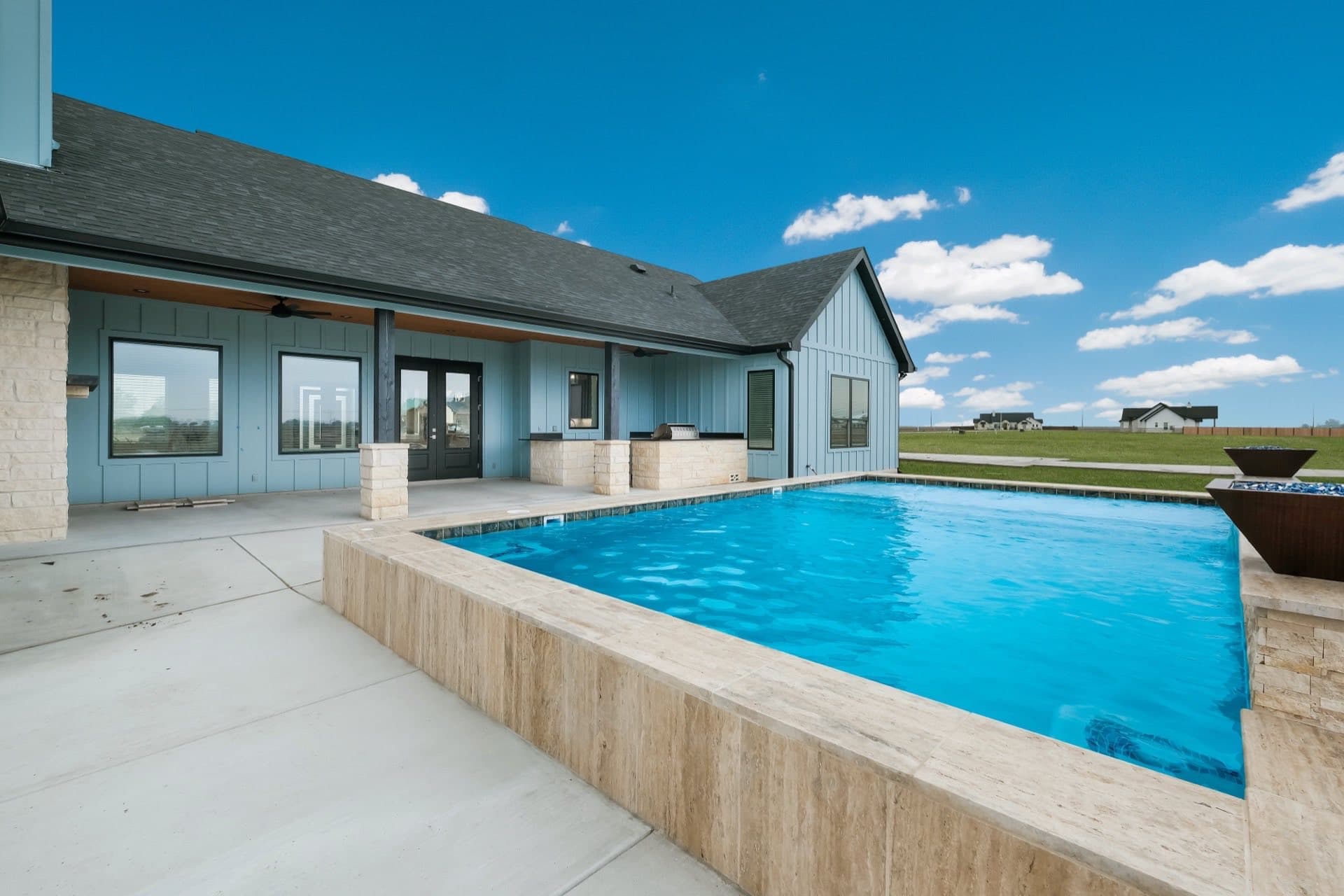 Back porch and pool of a finished TKG custom home