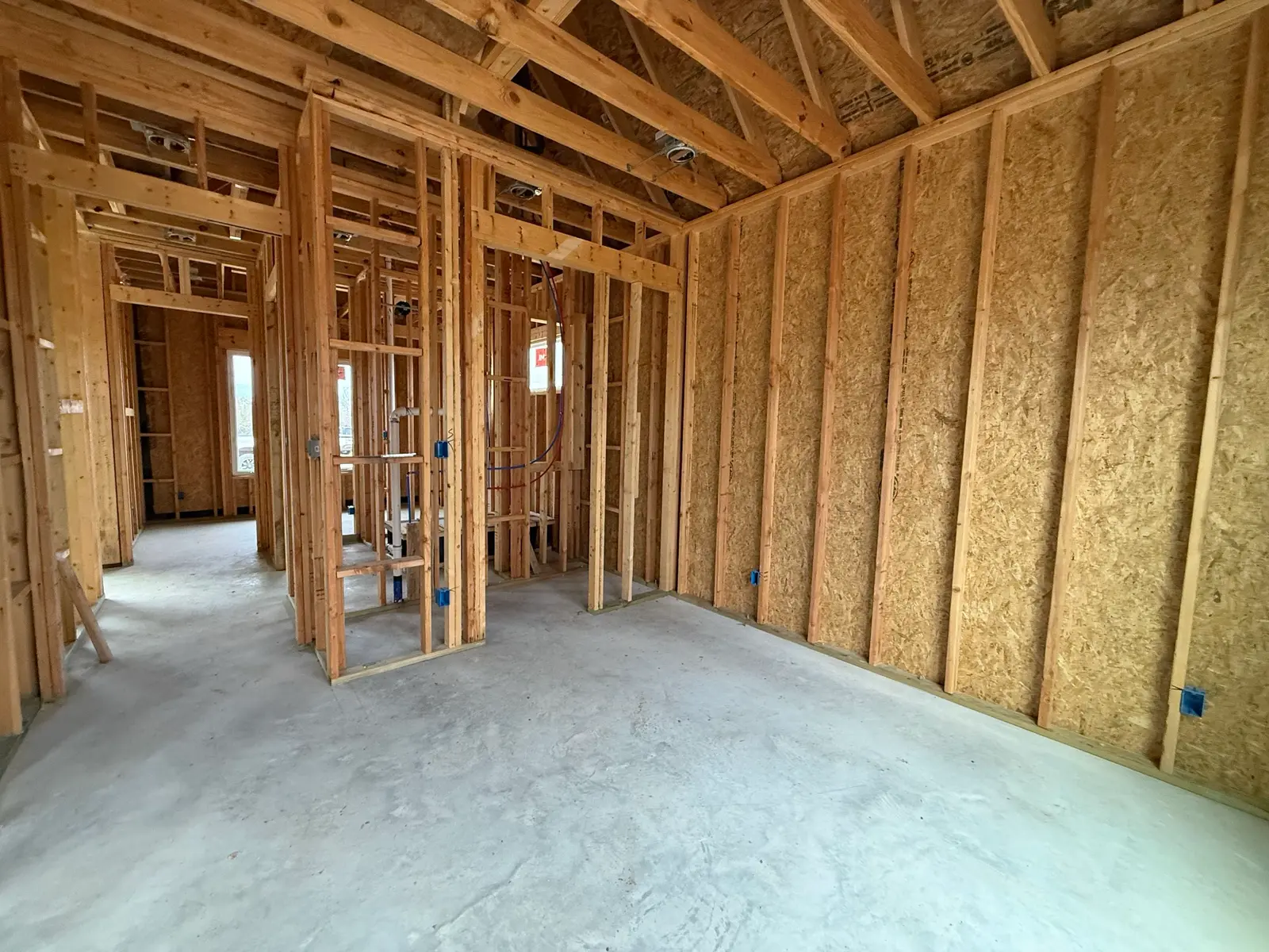 Framed interior of a TKG Custom Homes build, studs exposed before electrical